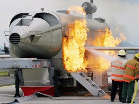1200px-US_Navy_040303-N-5821W-001_Personnel_at_NAS_Sigonella's_Fire_Department_battle_a_fire_while_training_with_the_a_Mobile_Aircraft_Fire_Trainer
